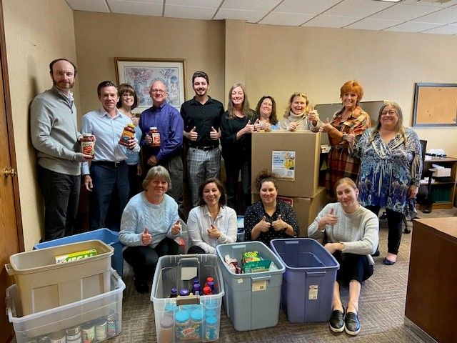 Employees at C&H's Wellesley office pose with the final donations.